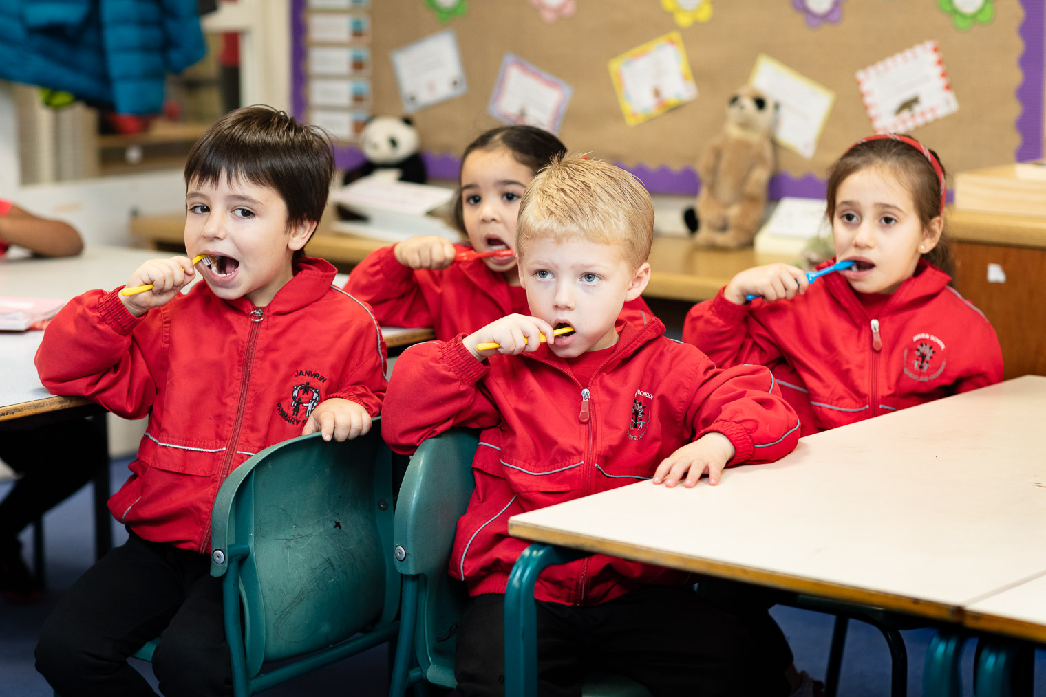 Young children brushing teeth in school