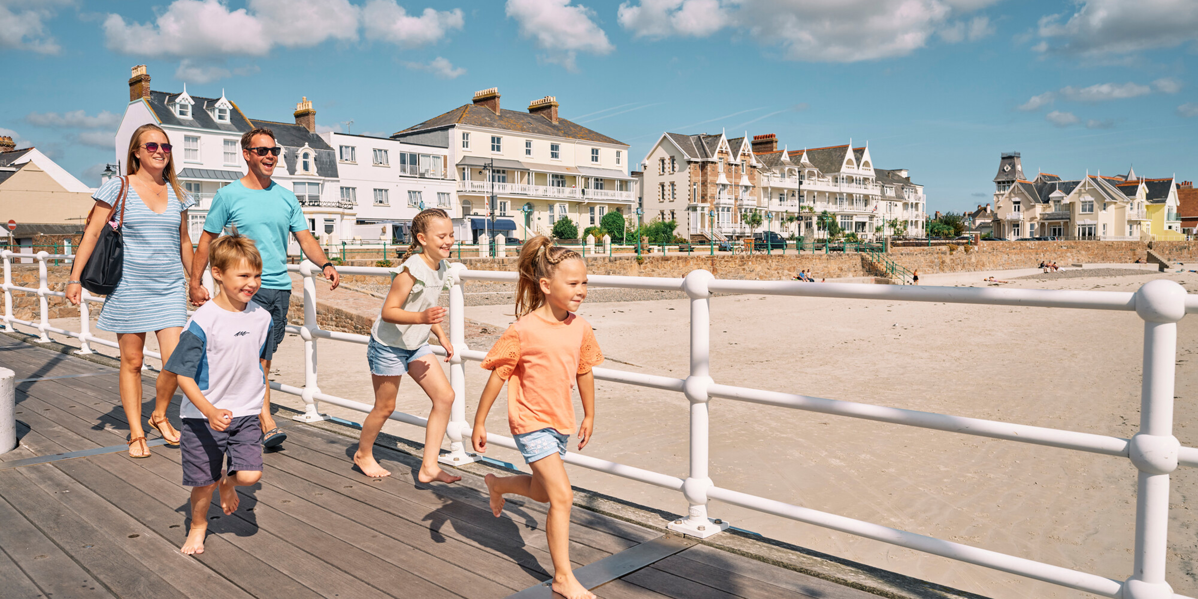 Family running along the pier